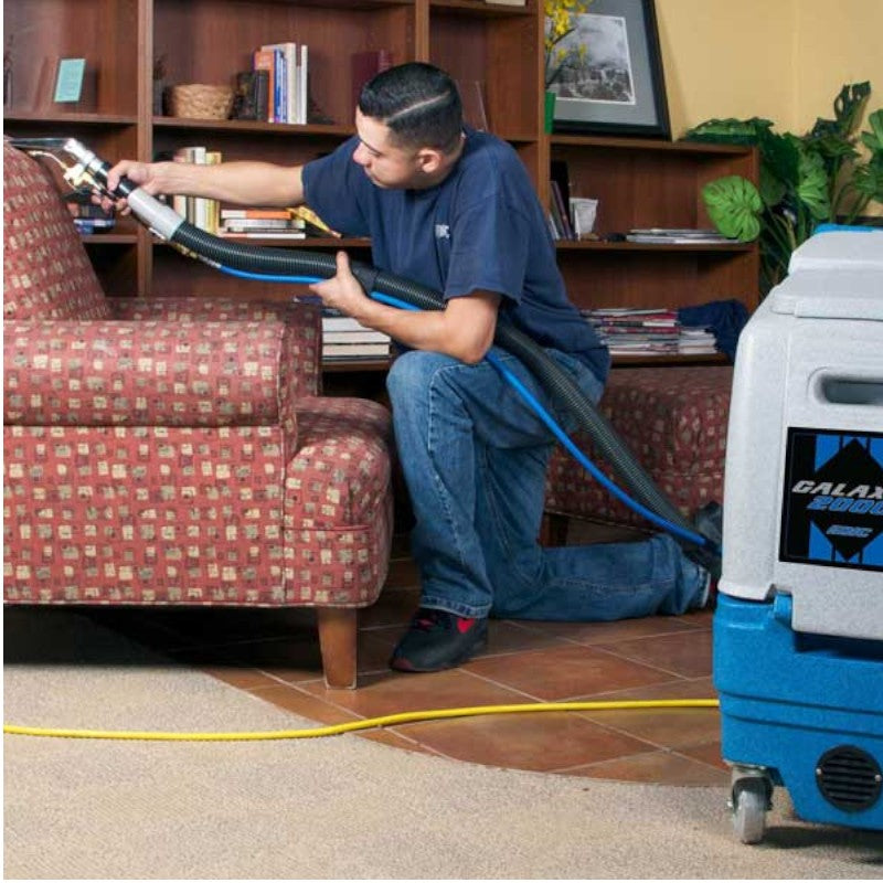 EDIC Galaxy 2000SX-HR Carpet Extractor - 100 PSI with Man Cleaning the Upholstery for Spotless Results