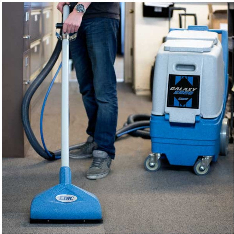 Man Cleaning the Carpet Using Wand with EDIC Galaxy 2000CX-HR Carpet Extractor for Deep Stain Removal